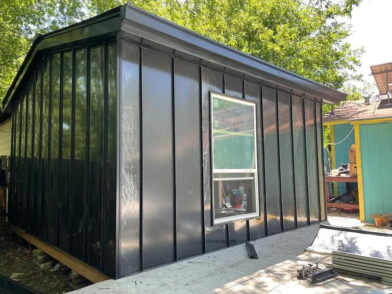 Black standing seam metal wall panels for Roof Inspection in De Soto