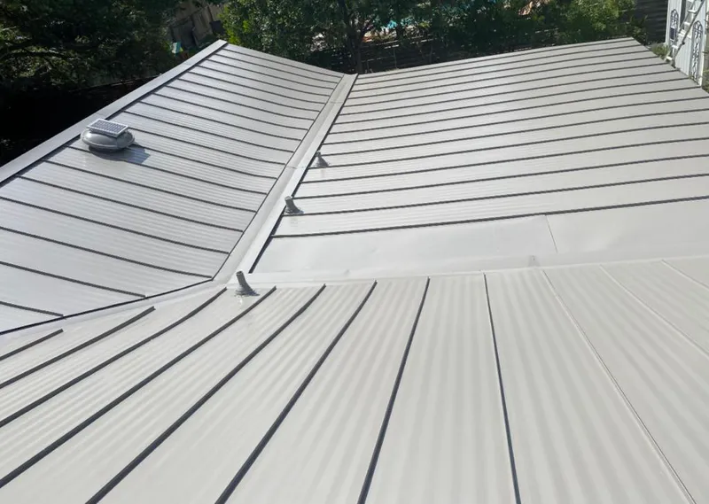 Solar attic fan installed on a metal roof for Roof Ventilation in De Soto